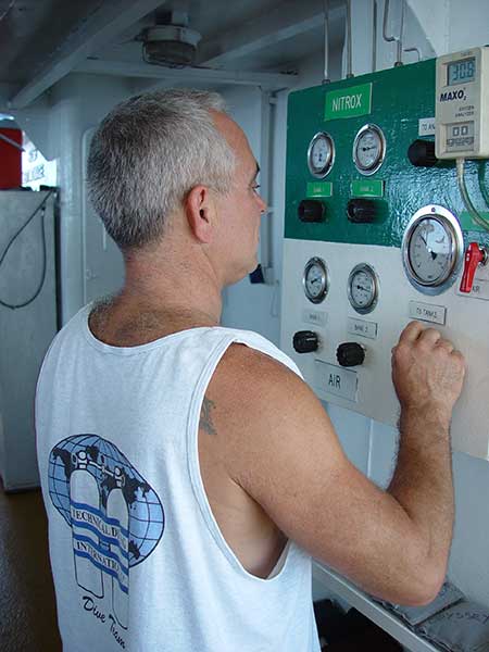 technician reading gauges