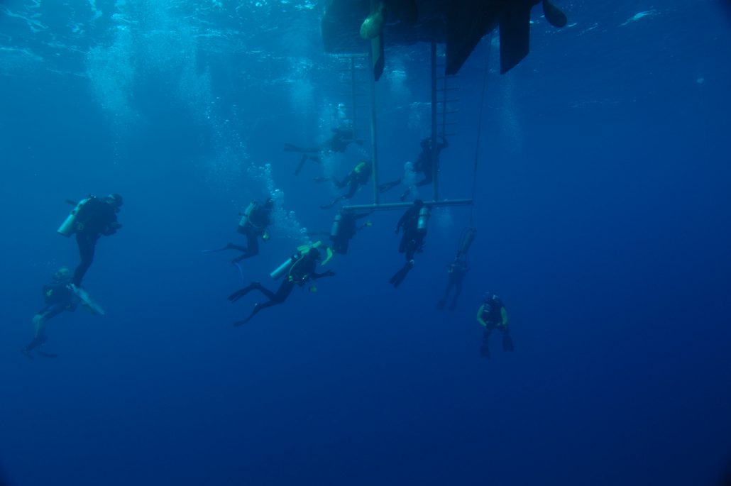 divers in Truck Lagoon near dive boat